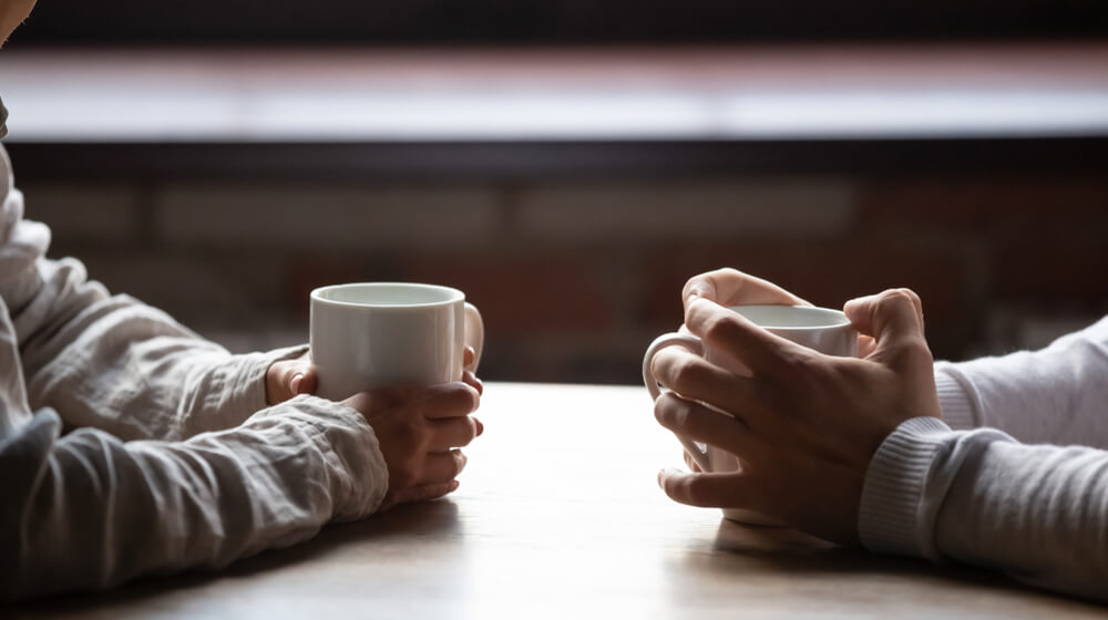 two people chatting about divorce over coffee