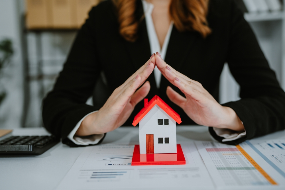 estate planning lawyer with her hands over house model