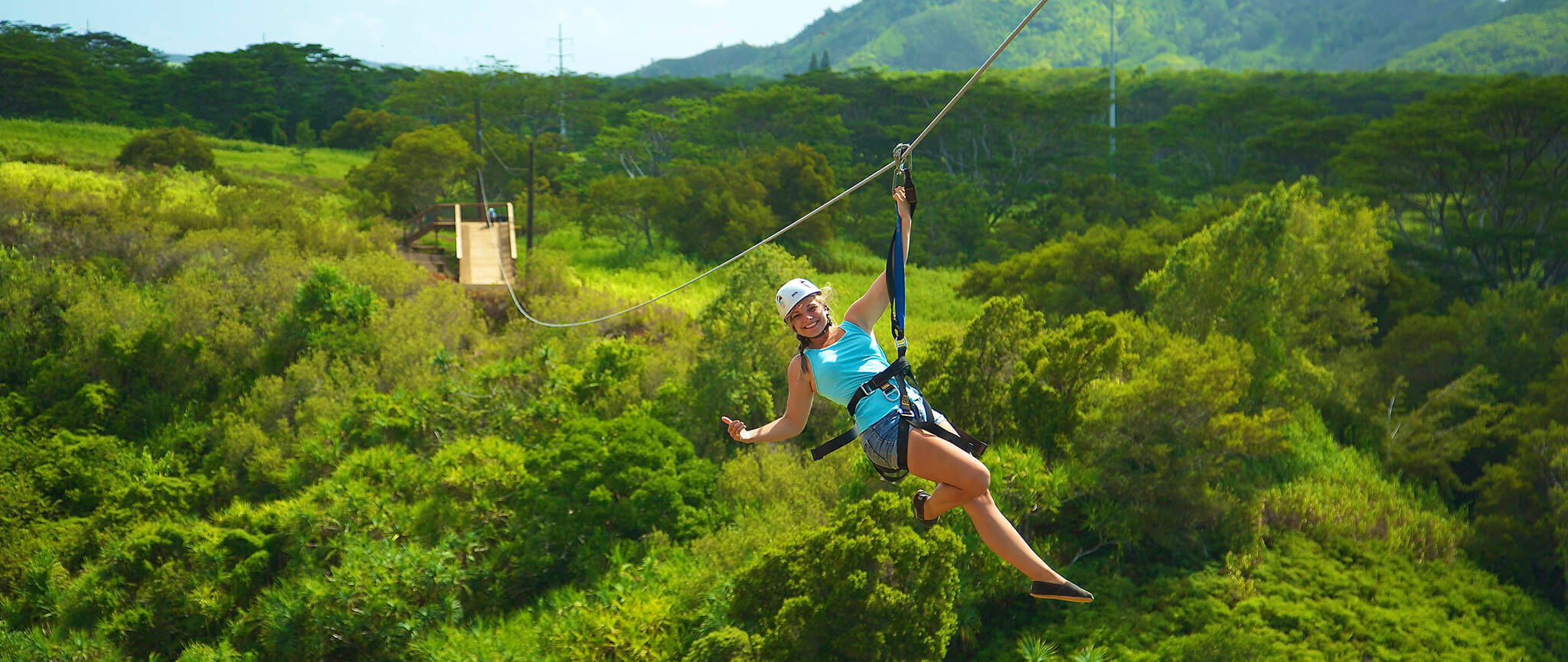 Woman ziplining on Skyline Hawaii's Lush Kauai course, near Koala